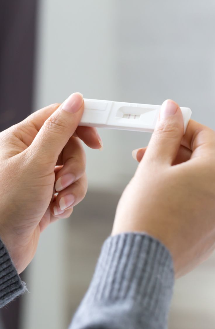Hands holding a pregnancy test