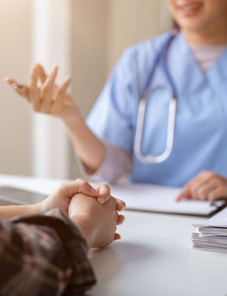 Doctor discussing symptoms with a patient at consultation