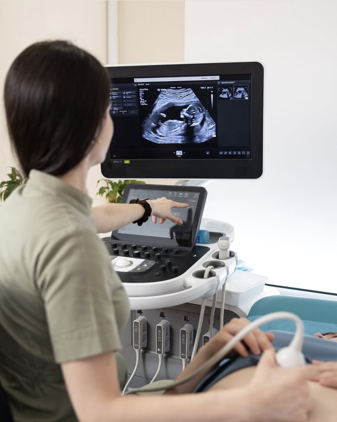 Sonographer performing an abdominal ultrasound scan