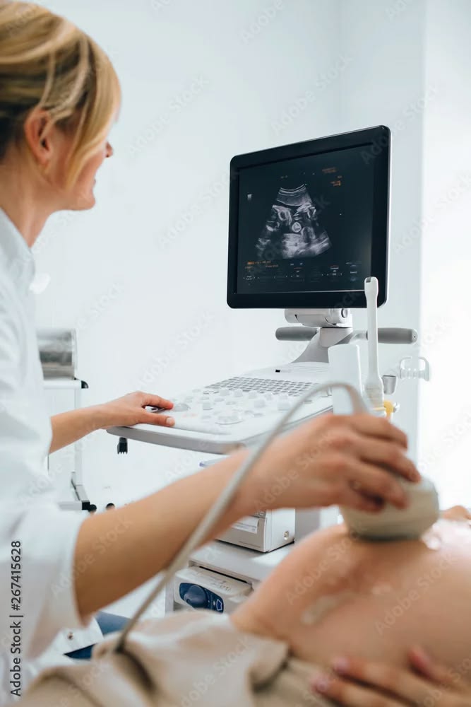Clinician performing a pelvic ultrasound scan
